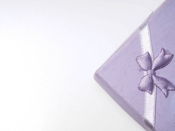 istock purple gift box with purple ribbon on a white isolated background 1289628543
