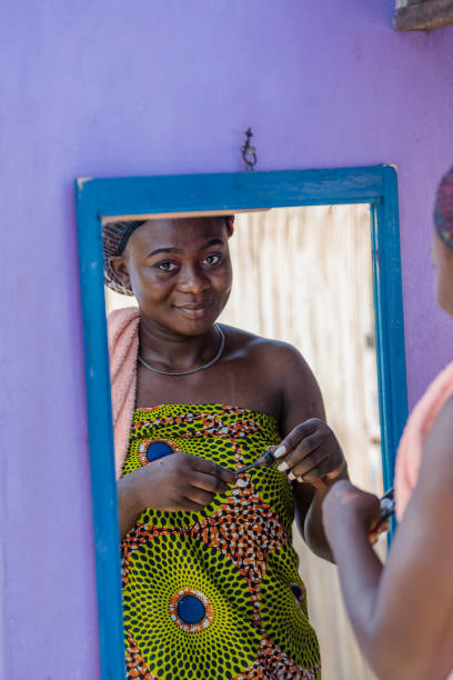 istock African woman doing her makeup outdoors 1289629564