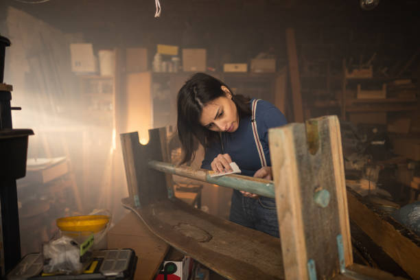 istock Female carpenter working with emery in workshop 1289630379