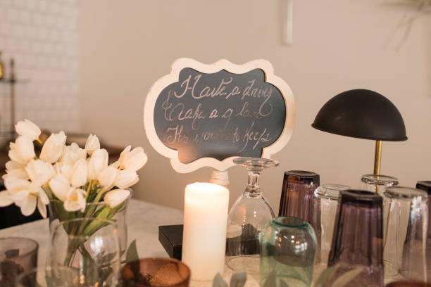istock Candle Surrounded by Assorted Jewel-Toned Drinking Glasses for Cocktail Hour Drinks at a Mid Century Modern Style Wedding Reception 1289631098