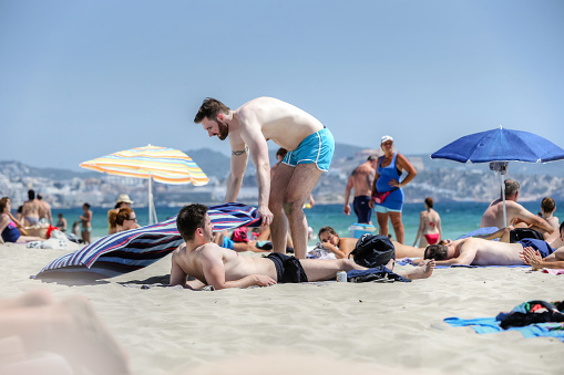 Ibiza, Spain - July 9, 2016: People enjoying the sunny weather on the beaches of Ibiza Spain