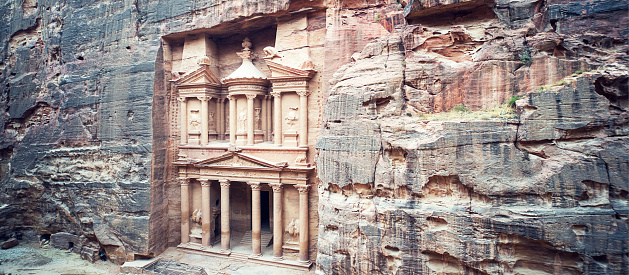 ancient treasury in Petra Jordan seen from the Siq. view from the top. main attraction of the lost city of Petra in Jordan. The temple is entirely carved into the rock. Ancient old architecture