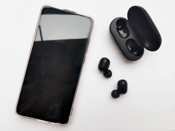 istock Top View Of Wireless Earphone And Mobile Phone On White Background 1289641779