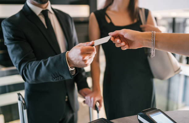 istock Business people makes card payment at check-in at reception. 1289641897