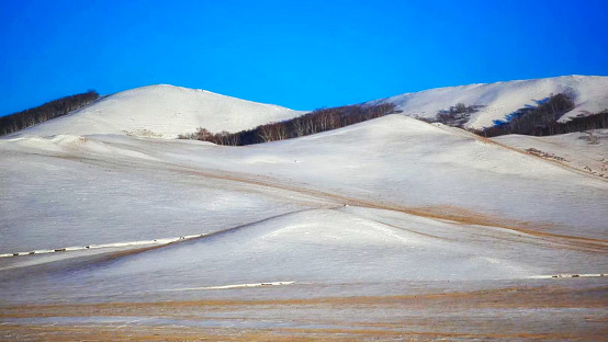 The  gorgerous snow-covered Wulanbutong Grassland, also known as the Ulan Buh Grassland, which is located on the south of the Hunshandake Sandland (part of the Hexigten Global Geopark) in the southern tip of Hexigten Banner in Chifeng of Inner Mongolia, China