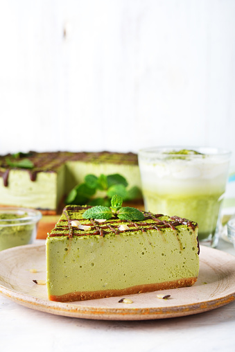 Cheesecake with japanese green matcha tea on white background