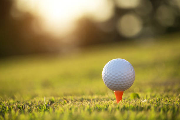 istock golf ball on tee in a beautiful golf course with morning sunshine 1289650652