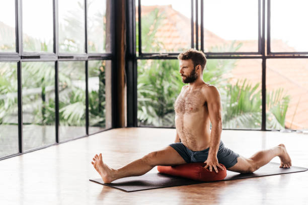 istock Yoga man workout in studio in front of a window 1289651568