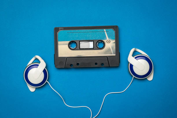 istock Blue headphones and a blue tape recorder on a blue background. 1289660189