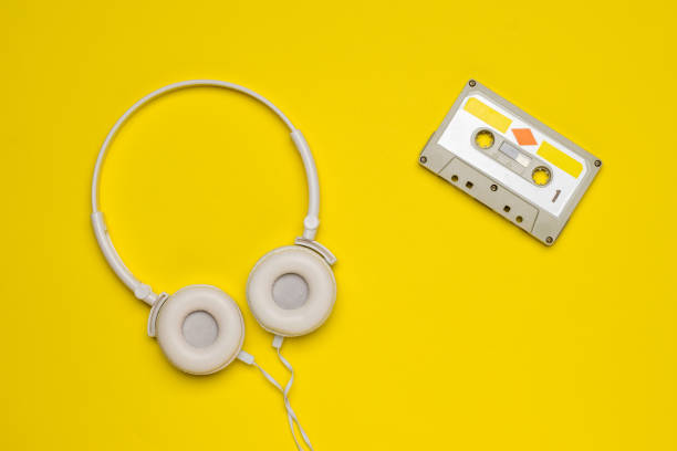 istock White headphones and a tape recorder on a yellow background. 1289660201