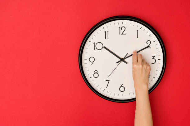 Human hand adjusting the hour clock Human hand adjusting the hour clock. hour hand stock pictures, royalty-free photos & images