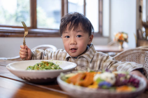 istock Asian boy eating pasta in restaurant 1289664212