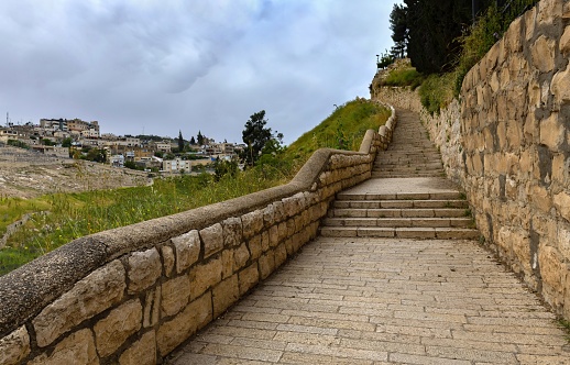 East Jerusalem, Palestine, May 2, 2019: Staircase in the valley between the Mount of Olives and the Old Town under cloudy sky.