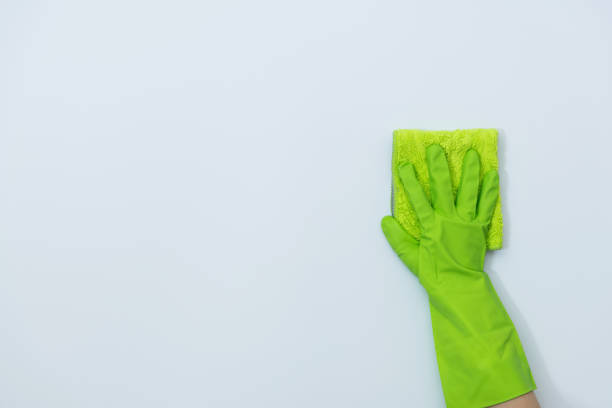 istock Woman hand cleaning white wall with rag 1289667737