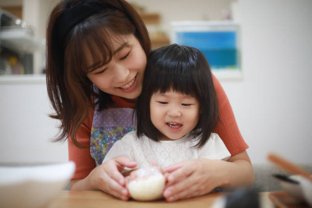 istock Parents and children holding rice balls 1289668614