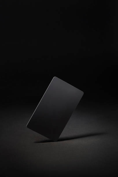 istock Blank black gift card isolated on black background 1289670305