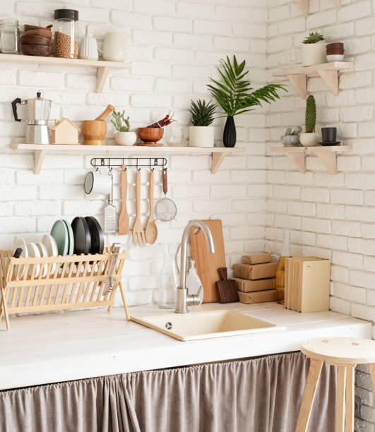 istock Rustic kitchen interior with white brick wall and white wooden shelves 1289672090
