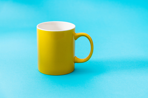Yellow mug on blue background