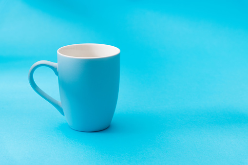 Blue mug on blue background.