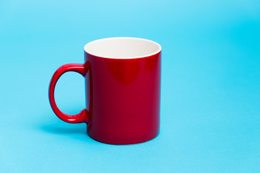 Red mug on blue background