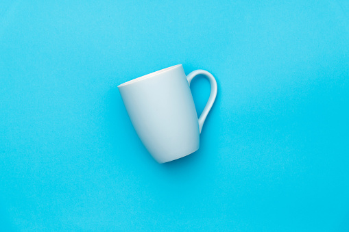 White mug on blue background
