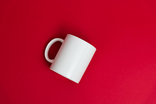 White mug on red background