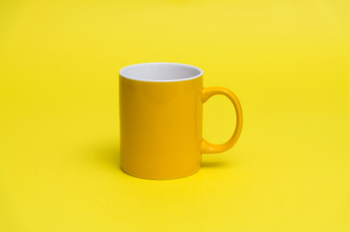 Yellow mug on yellow background