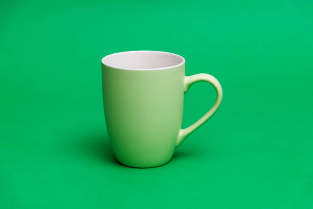 Green mug on green background.