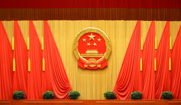 National emblem of China at the Great Hall of the People in Beijing, China National emblem of the People's Republic of China and Red flags at the Great Hall of the People in Beijing, China communism photos stock pictures, royalty-free photos & images