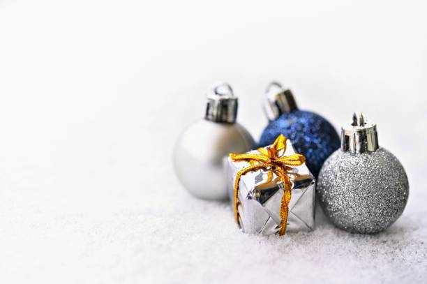 istock Christmas background. Beautiful decorations for the Christmas tree on real snow. Objects for the holidays and winter time. 1289680082