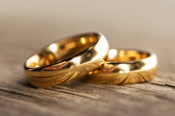 istock Golden wedding rings on wood 1289681402