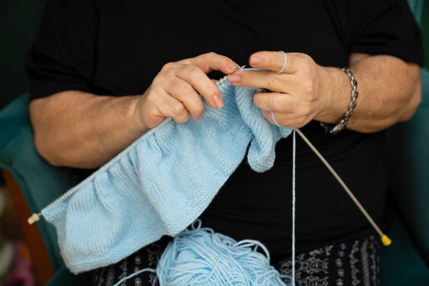 istock Middle aged woman knitting 1289682427