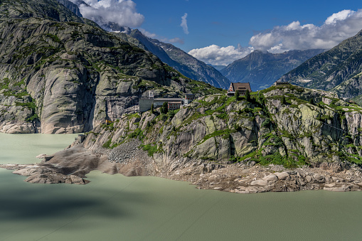 Aerial view of Grimselsee (Lake Grimsel) and Grimsel Hospice in sunny day during summer, Switzerland