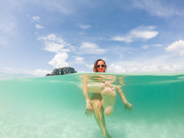 istock Woman enjoys tropical vacations, underwater shot 1289683425