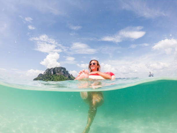 istock Woman enjoys tropical vacations, underwater shot 1289683429