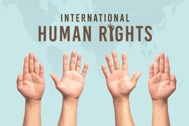 istock International Human Rights Day concept, raise hand up 1289686966