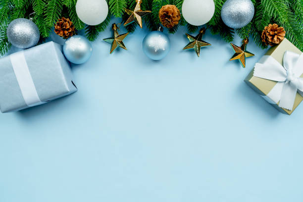 istock Christmas present and pine tree with xmas decoration on blue background 1289687141