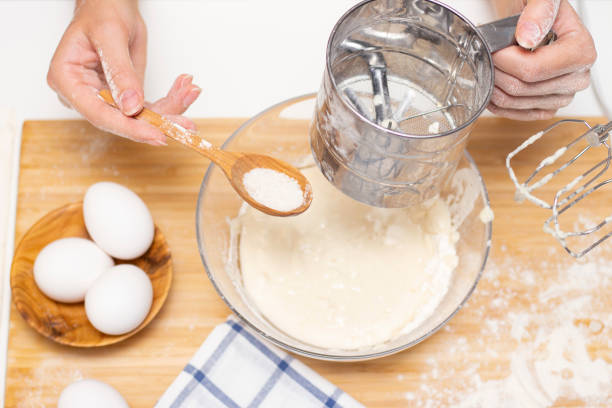 istock female hands hold a mixer for mixing dough 1289690568