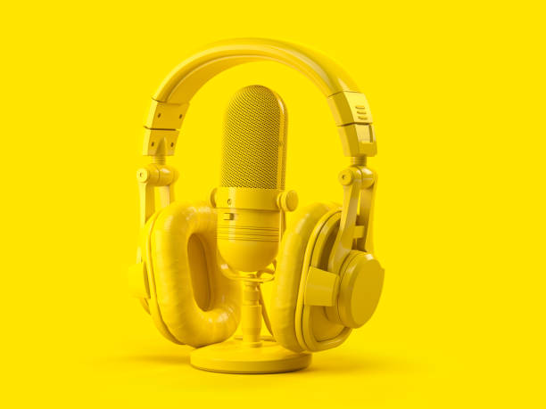 istock Yellow retro haedphones and microphone on yellow background. 1289692985
