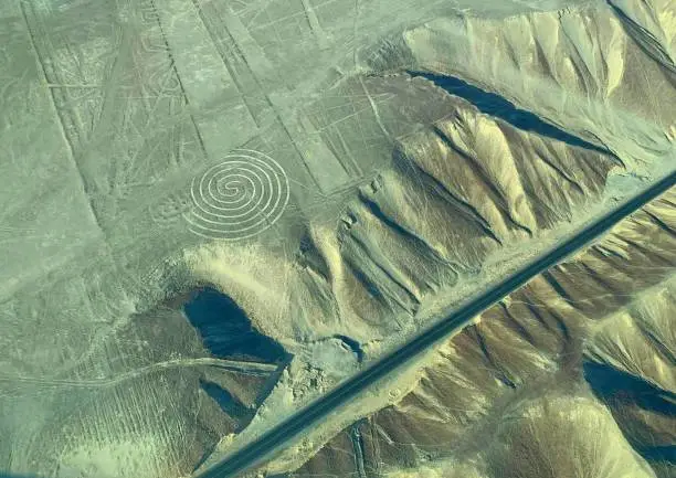 Photo of Geoglyph Spiral Aerial view geometric circle circular drawing line on soil Nazca (Nasca) desert Peru. Mysterious images on earth ground possibly made alien civilization for ancient irrigation. Nazca Lines Geoglyphs in Nasca desert, ancient culture.