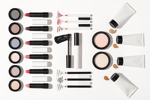 Beauty products , lipstick, face powder, mascara, eyeshadow, eyebrow pencil, foundation cream with strokes isolated on white background(with clipping path)