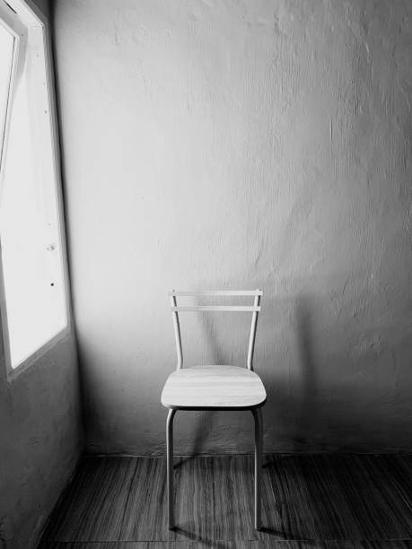 A old chair near window on black white mode