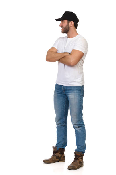 istock Young Man In Black Cap Is Standing With Arms Crossed And Looking Away 1289699740