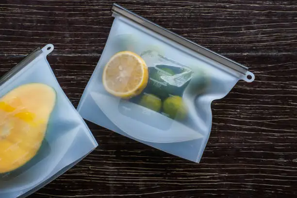 Photo of Fruits packed in environmentally safe silicone ziplock bags. Reusable eco-friendly kitchen products. Zero waste sustainable plastic free lifestyle