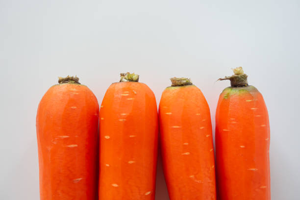 istock Fresh carrots isolated on white background 1289701269