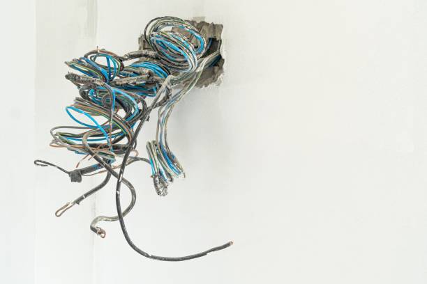 istock Electrical box and power wires in concrete wall 1289702237