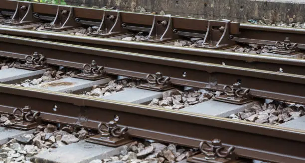 Railroad track fasteners or clamps holding steel tracks in their position