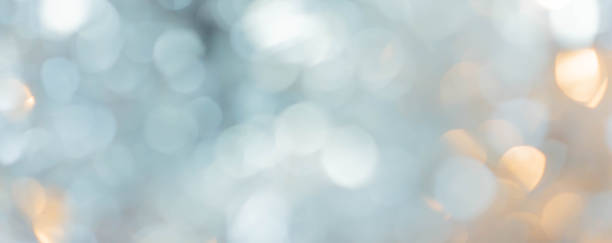 abstract blur beautiful glow silver and gold color background with circle bokeh light for christmas festival and happy new year season design as banner concept
