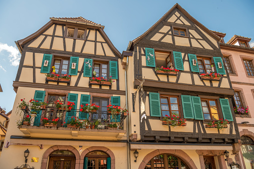 Kayserberg, France - July 1, 2020: French traditional half-timbered houses and in Kayserberg village in Alsace, France