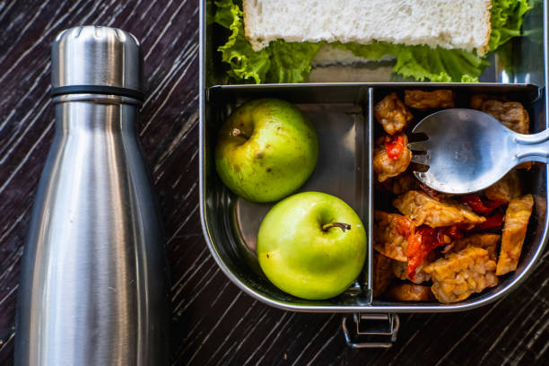 stainless steel food container or lunch box with healthy vegetarian meal and reusable thermo bottle on wooden background. eco-friendly kitchen products. zero waste sustainable plastic free lifestyle - lunch box lunch box metal imagens e fotografias de stock